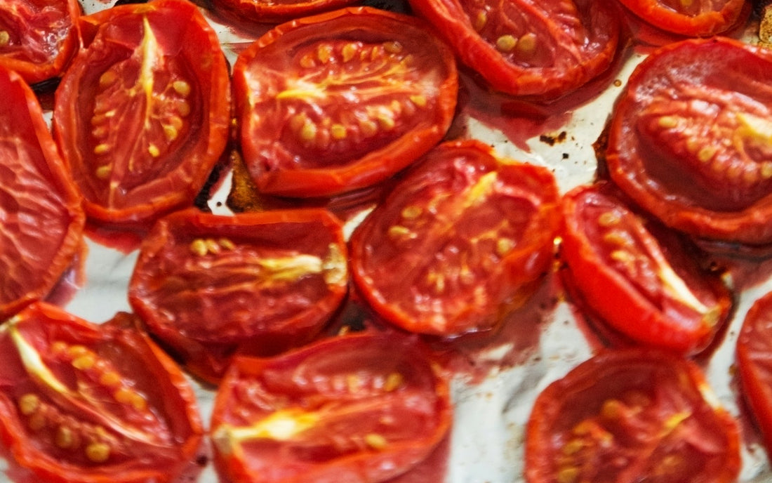 Halved tomatoes slow-roasted until wrinkled and jammy on a baking tray
